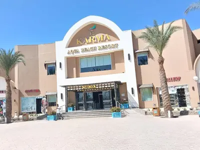 a shopping center with palm trees in front of it at Studio in Nubia Aqua Beach Twin Room in Hurghada in Hurghada