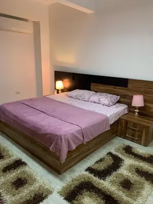 a bedroom with a large bed with a purple blanket at Schöne Hotel -Apartment in Sky El Gandoul Hurghada in Hurghada
