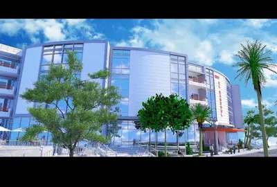 a tall building with trees in front of it at Schöne Hotel -Apartment in Sky El Gandoul Hurghada in Hurghada