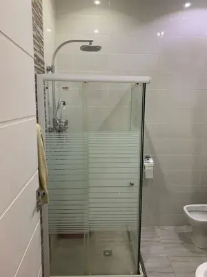 a glass shower in a bathroom with a toilet at Schöne Hotel -Apartment in Sky El Gandoul Hurghada in Hurghada