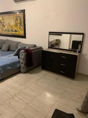 a living room with a couch and a mirror at Schöne Hotel -Apartment in Sky El Gandoul Hurghada in Hurghada
