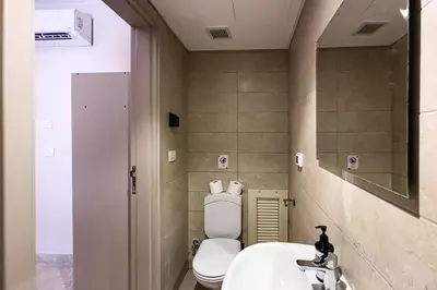 a bathroom with a toilet and a sink at The Golden Atrium 3BDR Pool View Free Pool & Beach Access in Hurghada