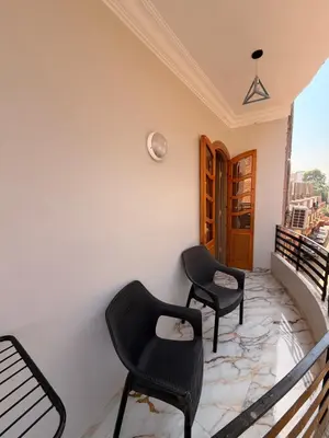 a balcony with two chairs and a table at Oscar Apartment 9 in Luxor