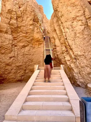 a woman walking up a set of stairs at Royal Home Dome Style - Ground Floor Apartment in Jazīrat al ‘Awwāmīyah