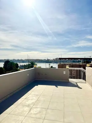 a balcony with a view of the water at Royal Home Dome Style - Top Floor Apartment in Jazīrat al ‘Awwāmīyah