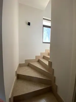 a staircase in a room with white walls at Gouna 3 bedrooms townhouse cyan in Hurghada