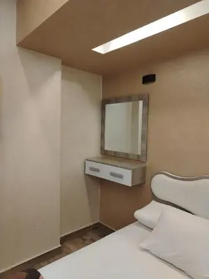 a bedroom with a bed and a mirror on the wall at Hurghada - star beach water front chalets - 3BR in Hurghada