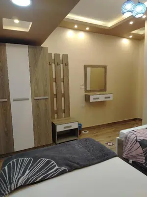 a bedroom with a bed and a mirror in it at Hurghada - star beach water front chalets - 3BR in Hurghada