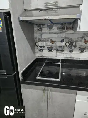a kitchen with a stove with bowls on it at Scandic in Hurghada