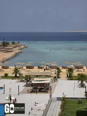 a view of a beach with umbrellas and the ocean at Scandic in Hurghada