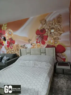 a bedroom with a bed with a flower patterned wall at Scandic in Hurghada
