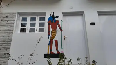 a painting of a cat on the side of a house at Celia Guest House in Luxor