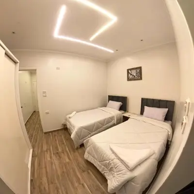 a room with two beds in it with a circular ceiling at Celia Guest House in Luxor