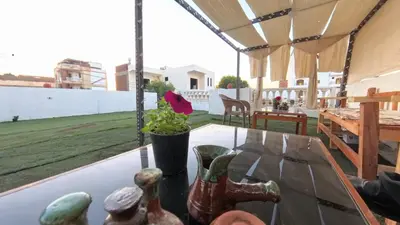 a glass table with figurines on top of a balcony at Celia Guest House in Luxor