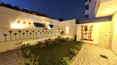 a patio with tables and chairs on the side of a building at Celia Guest House in Luxor