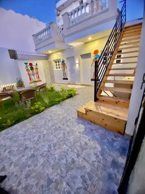 a house with a staircase and a patio at Celia Guest House in Luxor