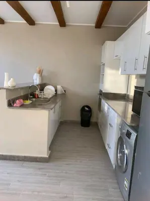 a kitchen with a sink and a washing machine at One Bedroom private pool in Hurghada