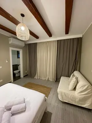 a bedroom with a white bed and a couch at One Bedroom private pool in Hurghada