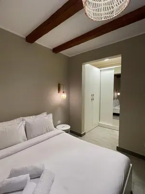 a bedroom with a large white bed and a mirror at One Bedroom private pool in Hurghada