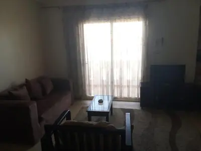 a living room with a couch and a coffee table at The Horizon House in Luxor