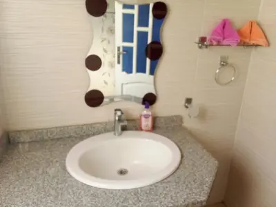 a white sink in a bathroom with a mirror at The Horizon House in Luxor