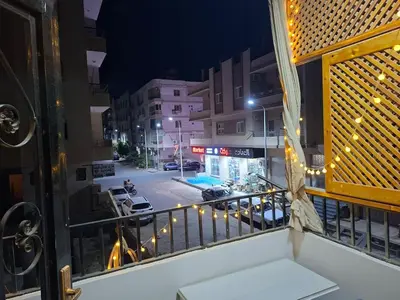 a balcony with a view of a street at night at Luxury family apartment in Hurghada in Hurghada