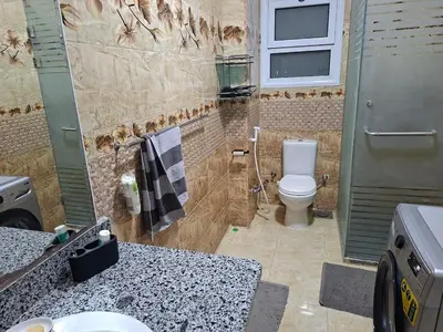 a bathroom with a toilet and a shower and a sink at Luxury family apartment in Hurghada in Hurghada