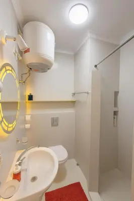 a bathroom with a sink and a toilet and a mirror at Oscar Apartment 8 in Luxor