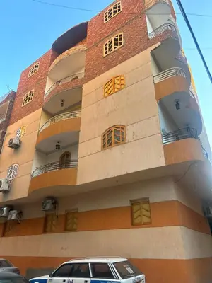 a building with a car parked in front of it at Oscar Apartment 10 in Luxor