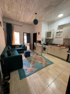 a living room with a couch and a kitchen at one bedroom at magawish hurghada in Hurghada