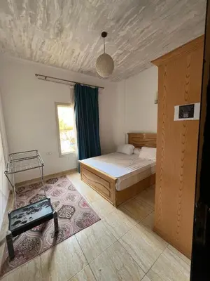 a bedroom with a bed and a table in it at one bedroom at magawish hurghada in Hurghada
