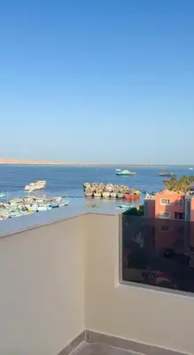 a view of the ocean from a window of a building at شقة فندقية امام المارينا 3 غرف 5 سراير in Hurghada
