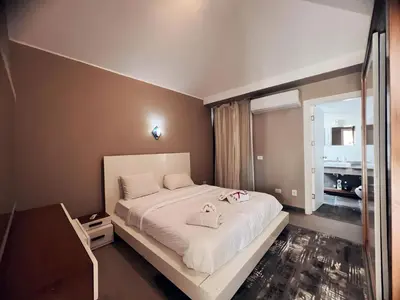a bedroom with a large white bed and a bathroom at Two Bedroom with Private pool in Hurghada