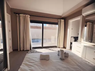 a bedroom with a large bed and a large window at Two Bedroom with Private pool in Hurghada