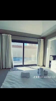 a bedroom with a bed and a large window at Two Bedroom with Private pool in Hurghada