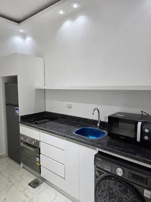 a kitchen with a sink and a microwave at Modern Studio with Pool and Private Beach Access in Hurghada