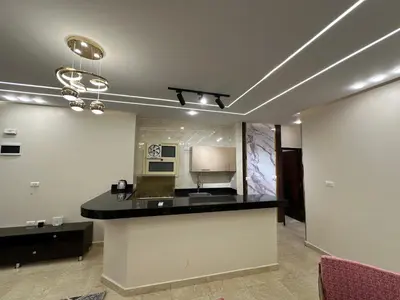 a kitchen with a black counter top in a room at الوفاء امام فندق بيروت in Hurghada