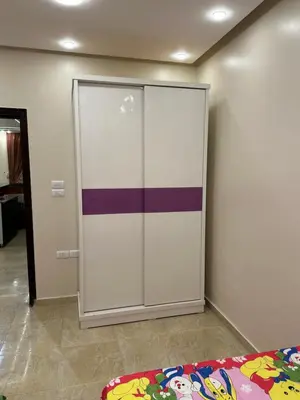 a sliding door in a room with a bed at الوفاء امام فندق بيروت in Hurghada