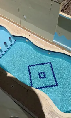 a swimming pool with a blue tile pattern on it at الوفاء امام فندق بيروت in Hurghada