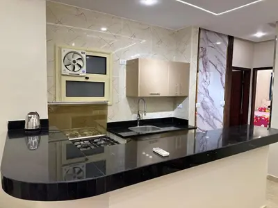 a kitchen with a black counter top and a sink at الوفاء امام فندق بيروت in Hurghada