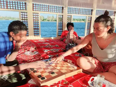a group of people playing chess on a boat at Traditional Felucca Sailing Boat Overnight in Aswan