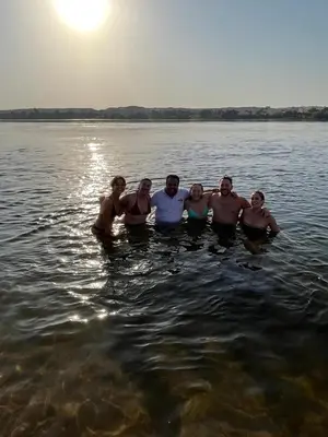 a group of people standing in the water at Traditional Felucca Sailing Boat Overnight in Aswan