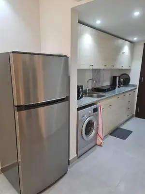 a kitchen with a stainless steel refrigerator and a washing machine at Happy Home Hurghada in Hurghada