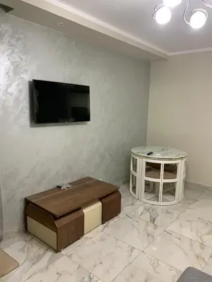 a living room with a flat screen tv on a wall at Happy Home Hurghada in Hurghada