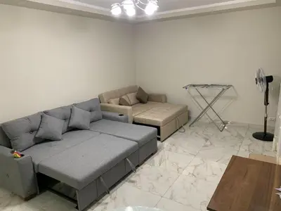 a living room with a couch and a table at Happy Home Hurghada in Hurghada
