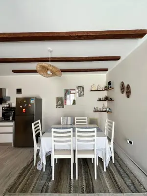 a white dining room with a white table and chairs at one Bedroom with Private pool in Hurghada