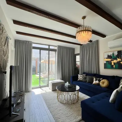 a living room with a blue couch and a table at one Bedroom with Private pool in Hurghada
