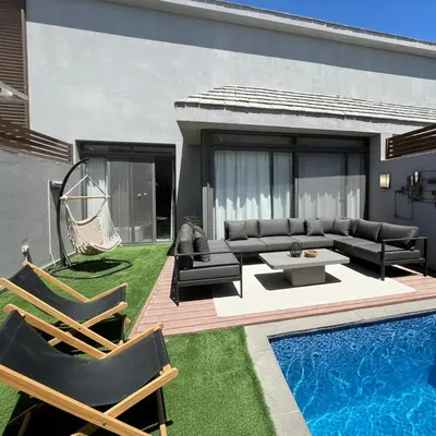 a backyard with a couch and a table and a pool at one Bedroom with Private pool in Hurghada