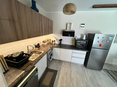 a small kitchen with a refrigerator and a sink at one Bedroom with Private pool in Hurghada