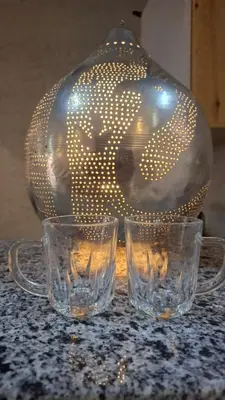 two glasses sitting on a table with a glass vase at Spacious and Chic 3 Bedroom Appartment Beautiful Rooftop Terrace Great location to explore Hurghada in Hurghada